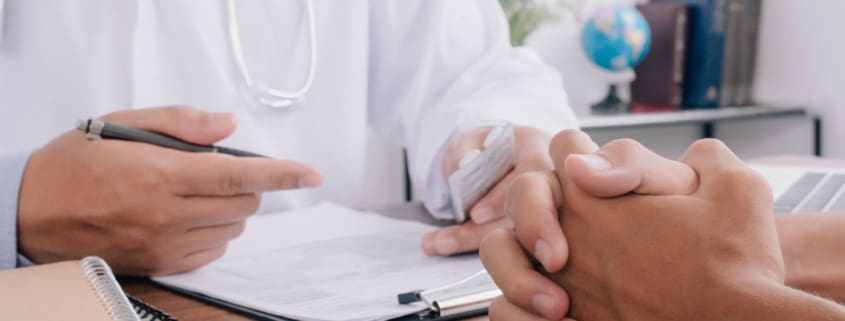 Close up of patient and doctor taking notes. healtcare and assistance concept.