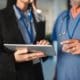 a doctor and a nurse looking at a tablet